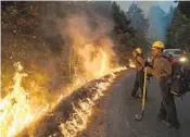  ?? NIC COURY AP FILE ?? Firefighte­rs monitor a controlled burn to help contain the Dolan fire near Big Sur in September 2020.