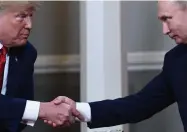  ?? Brendan Smialowski, AFP via Getty Imges file ?? U.S. President Donald Trump and Russian President Vladimir Putin shake hands ahead a 2018 meeting in Helsinki.