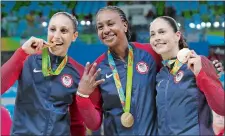  ?? ERIC GAY/AP PHOTO ?? Tamika Catchings, center, celebrates with ex-UConn greats Diana Taurasi, left, and Sue Bird, last month after the United States won the gold medal at the Summer Olympics in Rio. It was the fourth gold medal for the three stars. Catchings, who is...