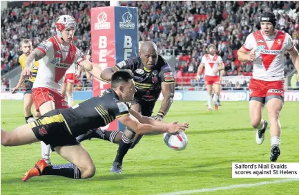  ??  ?? Salford’s Niall Evalds scores against St Helens