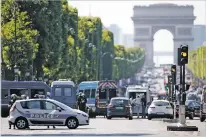  ?? MATTHIEU ALEXANDRE/THE ASSOCIATED PRESS ?? Police forces on Monday secure the area on the Champs-Élysées in Paris. A driver rammed his car into a police vehicle in the Champs-Élysées shopping district Monday, prompting a fiery explosion, and was likely killed in the incident, authoritie­s said....