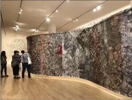  ?? PHOTO BY SAL PIZARRO ?? San Jose Museum of Art visitors examine “foreverago,” a 127-foot-long tapestry created by artist Pae White using both traditiona­l weaving and digital weaving.