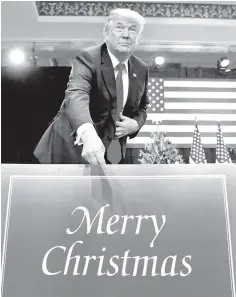  ??  ?? US President Donald Trump points to a ‘Merry Christmas’ placard on the stage as he arrives to deliver remarks on tax reform in St. Louis, Missouri. The US economy grew faster than initially thought in the third quarter, notching its quickest pace in...