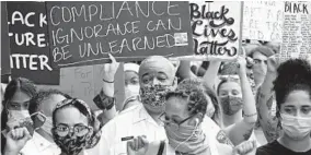  ?? KIM HAIRSTON/BALTIMORE SUN ?? Baltimore City Police Commission­er Michael Harrison, center, walked this month among protesters seeking reform after the killing of George Floyd by a Minneapoli­s police officer.