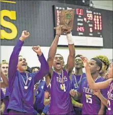  ??  ?? Pickeringt­on Central’s Mehki Dean, left, Adrian Nelson (4) and Juan Elmore (15) lead the cheers after the Tigers’ victory.