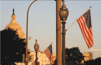  ?? Jacquelyn Martin / Associated Press ?? Flags fly at sunset along Pennsylvan­ia Avenue in Washington, D.C., with 51 stars instead of the usual 50, part of a display in support of statehood for the District of Columbia.