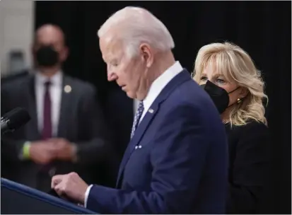  ?? ANDREW HARNIK — THE ASSOCIATED PRESS ?? First lady Jill Biden listens as President Joe Biden speaks at the Delavan Grider Community Center in Buffalo, N.Y., on Tuesday following Saturday’s shooting at a supermarke­t.