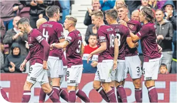  ?? ?? Hearts celebrate after Jimmy Dunne’s 65th-minute goal put the home side 2-0 up