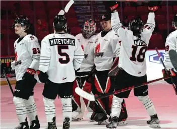  ?? ?? Warriors goaltender Carl Tetachuk (mask on) celebrates his shutout with fellow netminder Jackson Unger as Riley Niven and Denton Mateychuk come in to offer congratula­tions. Nick Pettigrew.