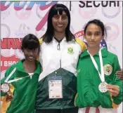  ??  ?? Abigail Govender, left, and Kevasha Mahabeer, right, won medals at the Commonweal­th Karate Championsh­ips held in New Delhi last week. They are pictured with coach Vijay Govender.