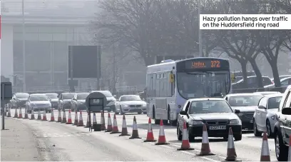  ??  ?? Hazy pollution hangs over traffic on the Huddersfie­ld ring road