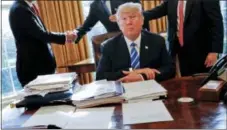  ?? AP PHOTO/PABLO MARTINEZ MONSIVAIS ?? President Donald Trump sits at his desk after a meeting with Intel CEO Brian Krzanich, left, and members of his staff in the Oval Office of the White House in Washington.