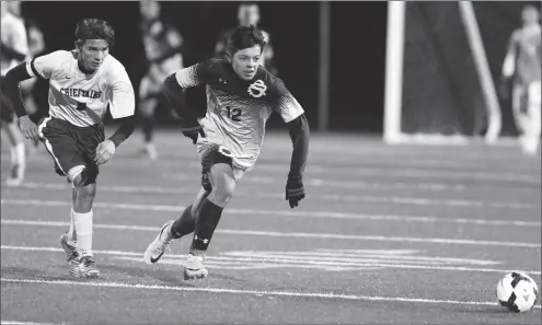  ?? Photo by Louriann Mardo-Zayat / lmzartwork­s.com ?? St. Raphael junior midfielder Cano Morales (12) chases down the ball during Wednesday night’s Division III semifinal shootout victory over No. 3 Ponaganset at Johnston. The No. 7 Saints will play No. 1 Cranston East in tomorrow afternoon’s Division III...