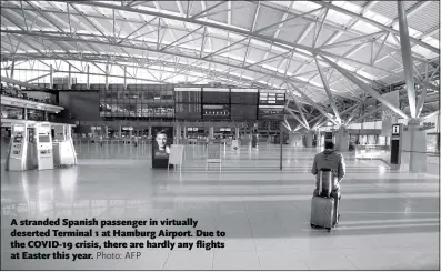  ?? Photo: AFP ?? A stranded Spanish passenger in virtually deserted Terminal 1 at Hamburg Airport. Due to the COVID-19 crisis, there are hardly any flights at Easter this year.