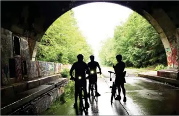  ?? MELANIE DG KAPLAN FOR THE WASHINGTON POST ?? The Pike 2 Bike trail along an abandoned section of the Pennsylvan­ia Turnpike passes through two tunnels, one longer than a mile.