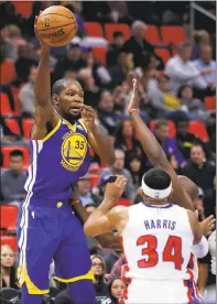  ?? DUANE BURLESON — ASSOCIATED PRESS ?? Warriors forward Kevin Durant passes the ball over Detroit Pistons forward Tobias Harris on Friday night.