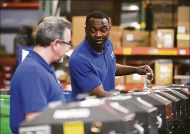  ?? Tyler Sizemore / Hearst Connecticu­t Media ?? Assembly workers Javier Torres, left, and Steve Joseph work on the production floor at Goodway Technologi­es’ headquarte­rs at 420 West Ave., in Stamford on Tuesday.