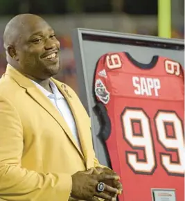  ?? PHELAN M. EBENHACK/AP ?? Former Tampa Bay Buccaneers star Warren Sapp smiles after being inducted in the team’s Ring of Honor ceremony at Raymond James Stadium in Tampa in 2013.