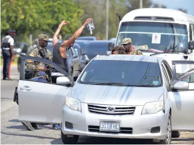  ??  ?? Searches taking place yesterday in Central Village, St Catherine.
RIGHT: Members of the Jamaica Defence Force search a car on St John’s Road, Spanish Town, St Catherine, yesterday. The operation forms part of the state of public emergency declared by...