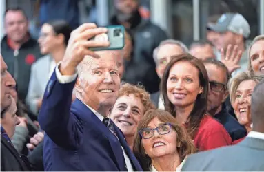  ?? EVAN VUCCI/AP ?? President Joe Biden takes a photo with supporters after speaking about his 2024 budget proposal on Thursday in Philadelph­ia. The budget plan would cut deficits by $2.9 trillion over the next decade.