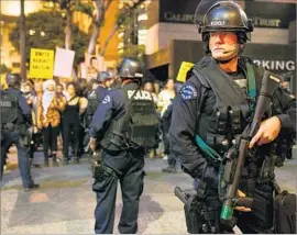  ?? Marcus Yam Los Angeles Times ?? LAPD officers surround protesters at a 2014 demonstrat­ion after a grand jury decided not to charge a Missouri officer in the shooting death of Michael Brown.