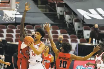  ?? Jay LaPrete / Associated Press ?? Ohio State's Justice Sueing tries to get off a shot as Illinois State’s Abdou Ndiaye goes airborne to defend against it. Sueing was 8for9 from the floor en route to 19 points in his team’s win.