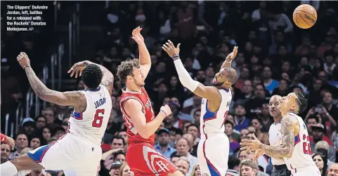  ?? AP ?? The Clippers’ DeAndre Jordan, left, battles for a rebound with the Rockets’ Donatas Motiejunas.