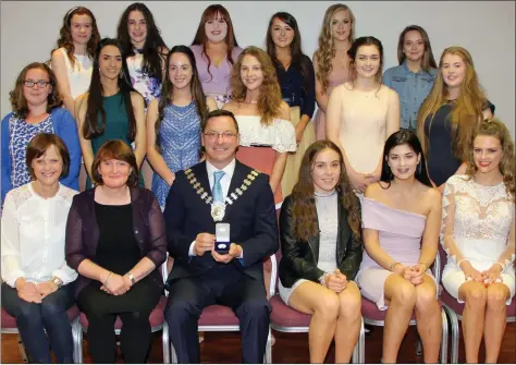  ??  ?? Our Lady of Lourdes transition year students receiving their award from New Ross Municipal District Council chairman Cllr Michael Sheehan.