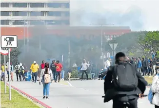  ?? Picture: EUGENE COETZEE ?? VARSITY STANDOFF: Police let off stun grenades at NMU to disperse students protesting over a variety of issues