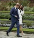  ?? MATT DUNHAM — AP FILE ?? In this file photo, Britain’s Prince Harry and his fiancee Meghan Markle pose for photograph­ers during a photocall in the grounds of Kensington Palace. Fans of the British royals will want to include castles, Westminste­r Cathedral and other sites...