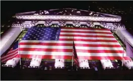  ?? —AP ?? NEW YORK: In this evening Friday photo, an American flag hangs on the front of the New York Stock Exchange. European stocks declined while most Asian markets rose Friday ahead of the first round of voting in France’s closely watched presidenti­al...