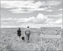  ?? Courtesy ?? Visitors walk the trail at Harrop Sandhills Park in northern Loup County. The park is a stop on the 2022 Nebraska Passport program,