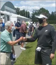  ?? MEIDANEWS GROUP PHOTO ?? Birds head coach Nick Sirianni, right, shakes the hand of Merrill Reese, the Voice of the Eagles, before the first rookie camp practice Friday at the NovaCare Complex.