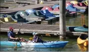  ??  ?? Andrew Stoddard, 18, left, and his brother Chase head to the dock after paddling a kayak on Lake Chabot in Castro Valley on Thursday.