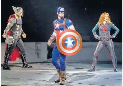  ?? PHOTOS COURTESY OF FELD ENTERTAINM­ENT ?? Central Floridians Justin Jackson, center, and Caitlin Hutson, right, take on the roles of Captain America and Black Widow in “Age of Heroes.” Along with Thor, left, they will battle to save the universe from the villainous Loki in an explosive live...