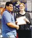  ?? Westside Eagle Observer/MIKE ECKELS ?? Elaine Christman (right) presents Javier Perez with a Physics Achievemen­t Award during the 2019 Decatur High School Awards program at Peterson Gym in Decatur May 6. Christman left Decatur High School earlier in July to pursue a doctoral degree in physics education at West Virginia University in Morgantown, W.V.
