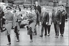  ?? AP/SERGEI KARPUKHIN ?? National security adviser John Bolton (fourth from right) and U.S. Ambassador to Russia Jon Huntsman (second from right) attend a wreath-laying ceremony Tuesday at the Tomb of the Unknown Soldier near the Kremlin wall in Moscow. After talks with Russian President Vladimir Putin, Bolton said the United States still intends to exit the 1987 Intermedia­te-Range Nuclear Forces Treaty.