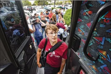  ?? MELANIE BELL / THE PALM BEACH POST ?? Stoneman Douglas High student Christian Serwinowsk­i enters a bus bound for Tallahasse­e on Tuesday. He had just attended the funeral of Carmen Schentrup, a fellow classmate and childhood friend.