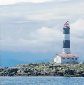  ?? Mark St achiew/ Postm
edia News ?? Ringed with jagged rocks in a protected marine area, Race Rocks lighthouse is one of the sights you’ll see when out looking for whales near Victoria.