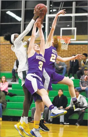  ?? Matthew Brown / Hearst Connecticu­t Media ?? Trinity Catholic’s Iyanna Lops (15) grabs a rebound from Westhill’s Peyton Hackett (3) and Vana Servos (2) in a FCIAC girls basketball game at Trinity Catholic High School’s Walsh Court in Stamford on Jan. 19. Lops has signed on to play at Cal-Bakersfiel­d.