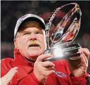  ?? Kevin C. Cox/TNS ?? Coach Andy Reid of the Kansas City Chiefs holds up the Lamar Hunt Trophy after defeating the Cincinnati Bengals in the AFC Championsh­ip Game on Sunday in Kansas City, Mo.