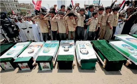  ?? AP ?? Yemeni people attend the funeral of victims after an airstrike by the Saudi-led coalition that killed dozens of people last month in an "apparent war crime."