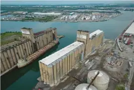  ?? ?? Great Lakes freighter C.T.C. No. 1 rests at the Illinois Internatio­nal Port District facility on Lake Calumet in Chicago on Aug. 10. It has been lying between two grain elevators at the port since 1982.