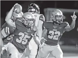  ?? CHARLES TRAINOR JR. ctrainor@miamiheral­d.com ?? St. Thomas Aquinas linebacker Christian Gonzalez, left, celebrates after recovering a fumble for a touchdown against American Heritage on Friday in Fort Lauderdale.