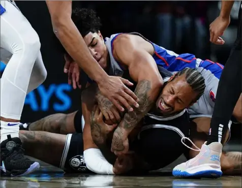  ?? Frank Franklin II/Associated Press ?? Brooklyn’s James Johnson, right, fights for control of the ball with Detroit’s Killian Hayes Tuesday night in New York.