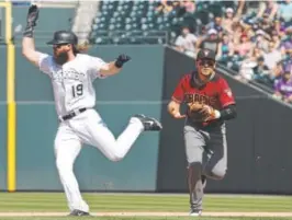  ?? Joe Mahoney, Getty Images ?? Rockies center fielder Charlie Blackmon runs into an out between first and second base during the fifth inning of Sunday’s game.