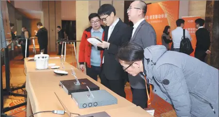  ?? PHOTOS PROVIDED TO CHINA DAILY ?? Visitors look at Aruba’s new products during a launch event in Beijing in December 2018.