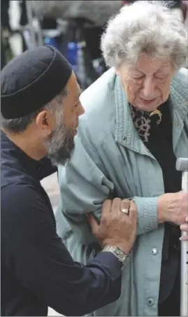  ?? PHOTO: AP ?? Jewish pensioner Renee Rachel Black, 93, is comforted by Imam Sadiq Patel as they pay their respects at a vigil in Manchester on Tuesday