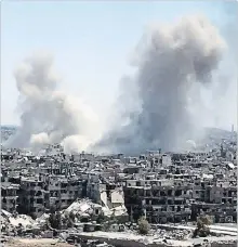  ?? THE ASSOCIATED PRESS ?? Smoke rises after Syrian government airstrikes and shelling hit in Hajar al-Aswad neighbourh­ood held by Islamic State militants, southern Damascus, Syria, Tuesday.