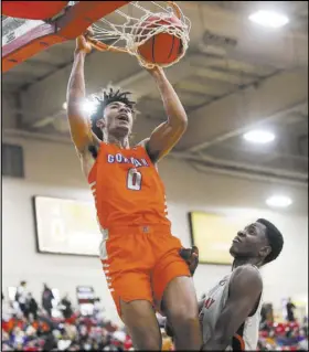  ?? Chase Stevens Las Vegas Review-Journal @csstevensp­hoto ?? Bishop Gorman’s Isaiah Cottrell dunks over Findlay Prep’s Alex Tchikou during the first half Saturday at South Point Arena.